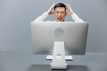 manager sits at a desk in front of a computer Internet Gray background