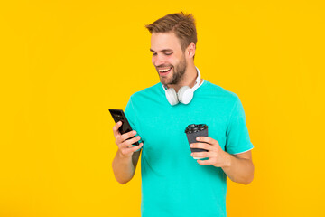 typing and texting. check sms and email. happy smiling man chat online with coffee.