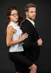 sensual colleague experts. man and woman in glasses. business partners on black background.