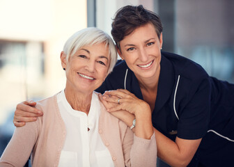 I have a pillar of strength in her. Cropped portrait of a young female nurse embracing a senior woman sitting in a wheelchair in a nursing home.