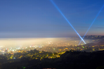 Naklejka na ściany i meble City of Hollywood with two light beam in the evening hour