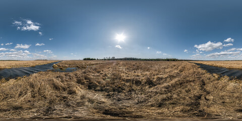 360 hdri panorama view among farming field near melioration reclamation canal  with sun and clouds in sky in full seamless equirectangular spherical projection, ready for VR AR virtual reality content