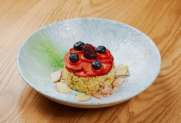 porridge garnished with strawberries and blueberries