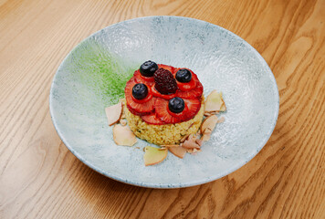 porridge garnished with strawberries and blueberries