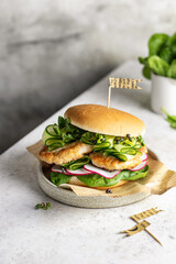 Homemade burger with meat, spinach, cucumber, radish and microgreens. Fast food still life