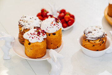 decorated panettones and cruffins on serving plates with rabbits. easter cakes. 