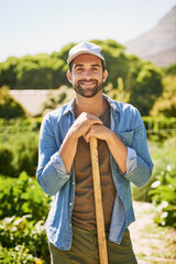 Plant today, harvest tomorrow. Portrait of a happy young farmer holding a spade while posing in the...
