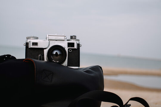 Retro film camera on the beach