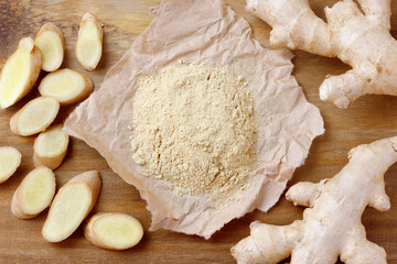 Ground ginger powder on paper over rustic wooden table