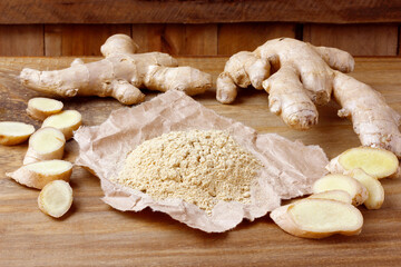 Ground ginger powder on paper over rustic wooden table