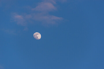 Blue sky and moon with clouds (copy space).