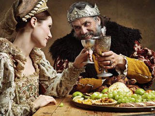 Maybe a full goblet will cheer you up mlady. A mature king feasting alone in a banquet hall.