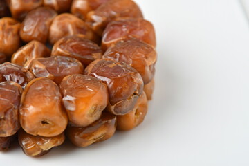 Fototapeta premium Arabic dates, sugary dates on the white 