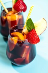 Spanish summer cocktail Sangria served in glasses decorated with fresh fruits