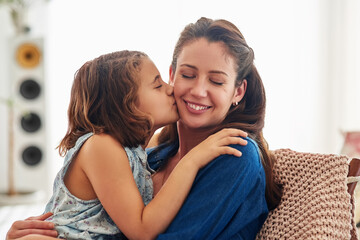 Love is beautiful to express but even better to feel. Cropped shot of a young girl kissing her mother at home.