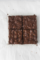 Dark chocolate brownies with caramel on parchment paper