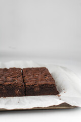 Dark chocolate brownies with caramel on parchment paper