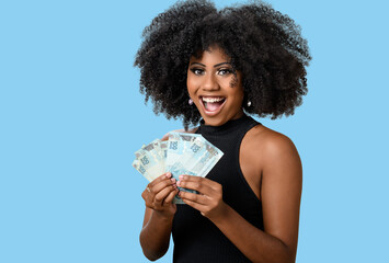 woman holding money,  brazilian money, on blue background