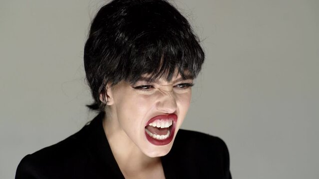 Shouting mouth, screaming face. Angry stressed woman screaming with anger and rage.
