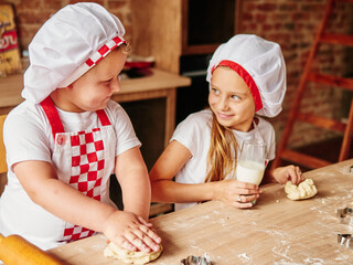 Two kids cooking in a domestic kitchen. Happy family, happy children concept