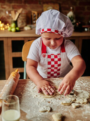 A smart kid boy is cooking at the home kitchen. Happy family, happy children concept