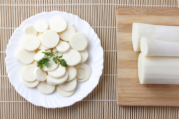 Sliced palm heart palmetto salad on plate over rustic wooden table