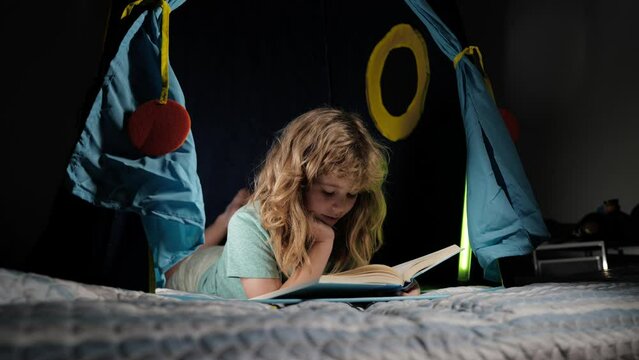 Kid boy reading books. Happy childhood, dreaming child read bedtime stories, fairystory or fairytale.