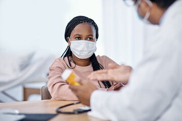 Listening to the doctors instructions. Shot of a young woman receiving medication from a doctor during a consultation.