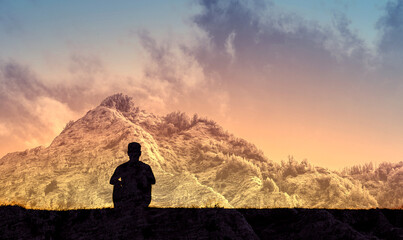 Man looking at mountain view with feelings of peace and solitude in nature 
