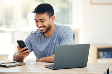 Make today your best day. Shot of a young businessman using a phone in an office at work.