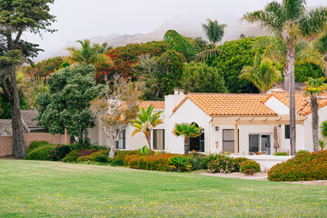 Beautiful houses with nicely landscaped front the yard in small beach town, California.