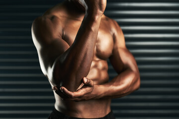 Strengthen the muscles around your joints. Studio shot of an unrecognizable man examining an elbow...