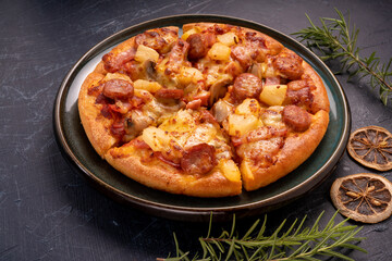 Mushroom and Sausage Pizza with cheese on black plate, Mushroom and Sausage Pizza on black plate on black background.