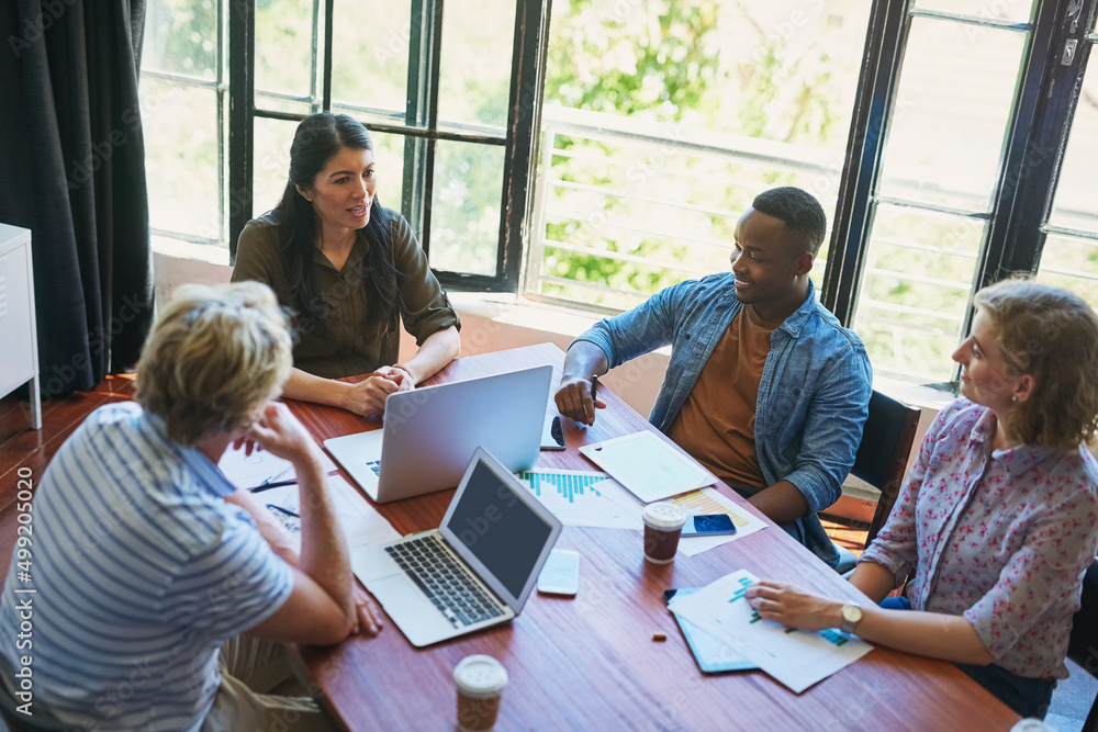 Poster driving productivity with efficient teamwork. shot of a diverse group of businesspeople having a mee
