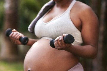 Im preparing my arm muscles for the workout theyll get when baby arrives. Cropped shot of a...