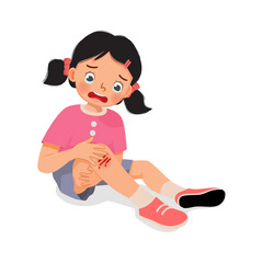 sad little girl has a knee injury crying holding her scratch bleeding leg with bruises after fell down