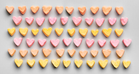 Delicious heart shaped marshmallows on grey background