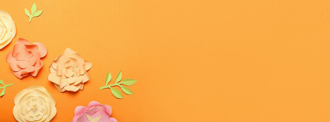 Beautiful handmade paper flowers on orange background with space for text