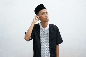 Asian muslim man doing thinking gestire, looking for idea over white background