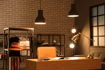 Modern workplace with notebooks and glowing lamps in dressing room
