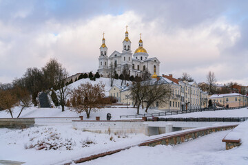 Fototapeta na wymiar View of the Assumption Mountain, the Holy Spirit Monastery and the Holy Assumption Cathedral on the banks of the Western Dvina and Vitba rivers on a winter day, Vitebsk, Belarus