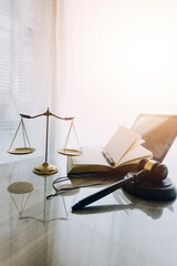 law books and scales of justice on desk in library of law firm. jurisprudence legal education concept. - obrazy, fototapety, plakaty