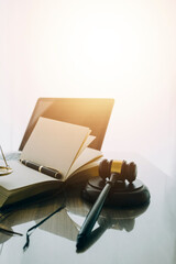 law books and scales of justice on desk in library of law firm. jurisprudence legal education concept.