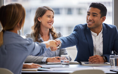 Thank you for letting me be a part of the team. Shot of two businesspeople shaking hands during a meeting in the office.