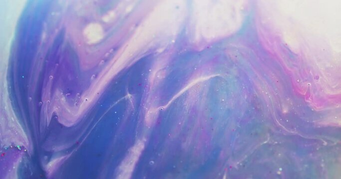 Ink water mix. Marble texture. Floating paint. Blur iridescent purple pink blue color fluid wave flow abstract background shot on RED Cinema camera.