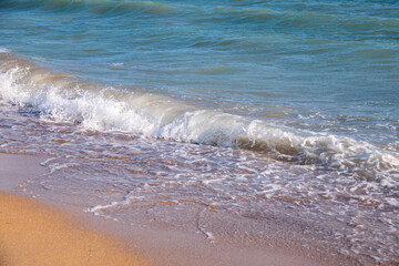 Soft wave of the sea on the sandy beach.