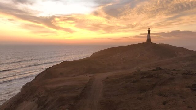Magical sunset in a lighthouse, the cliffs with sea birds. Puerto Eten at sunset, Lambayeque, Peru