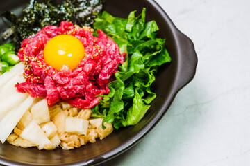Yukhoebibimbap, Korean style Beef Tartare Bibimbap : This is a bowl of rice topped with seasonal namul (seasoned vegetables) and fresh yukhoe (chopped raw beef) and served with seasoning. Lean fresh r
