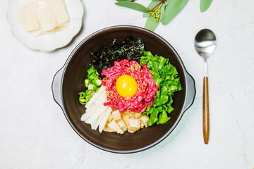 Yukhoebibimbap, Korean style Beef Tartare Bibimbap : This is a bowl of rice topped with seasonal namul (seasoned vegetables) and fresh yukhoe (chopped raw beef) and served with seasoning. Lean fresh r