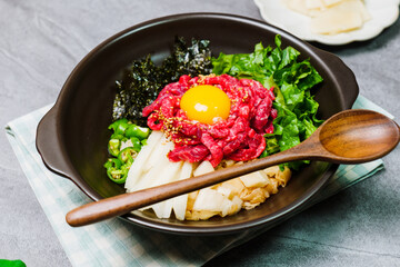 Yukhoebibimbap, Korean style Beef Tartare Bibimbap : This is a bowl of rice topped with seasonal namul (seasoned vegetables) and fresh yukhoe (chopped raw beef) and served with seasoning. Lean fresh r